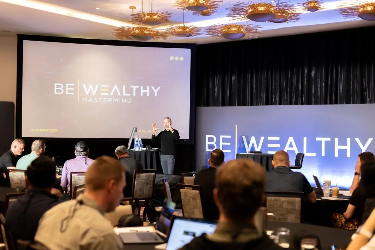 Brett Tanner speaking to a Be Wealthy mastermind room