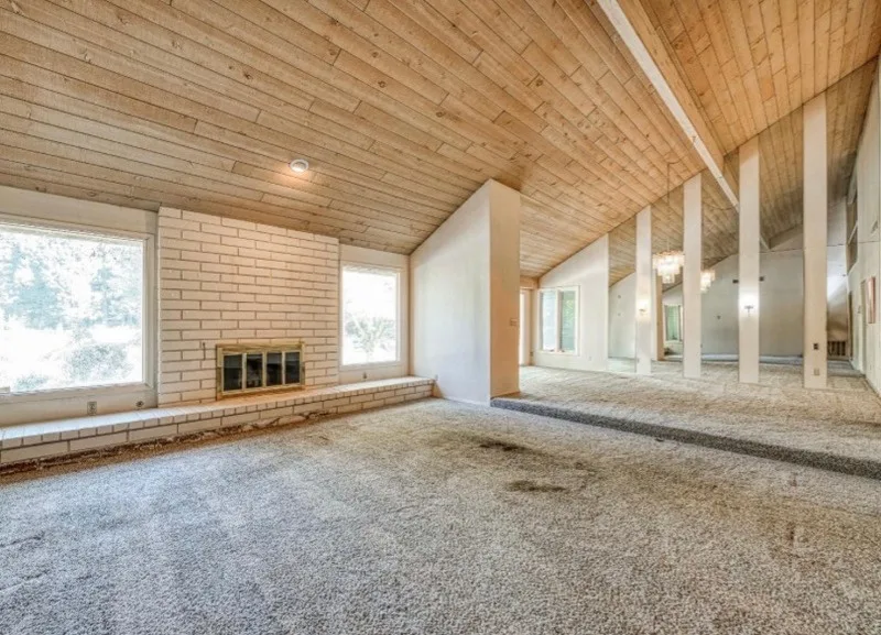 Empty living room of the Fresno house, stained carpet and vacant rooms