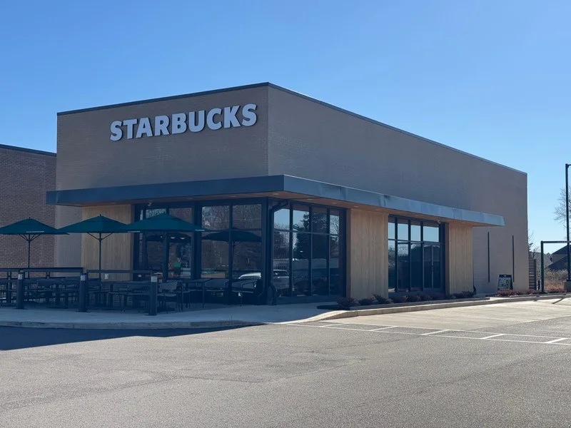 Wide view of the brand new Starbucks building in Oakland, Tennessee under a clear blue sky